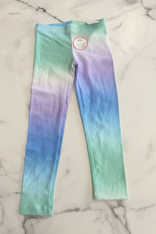 Colorful tie-dye leggings on a marble surface